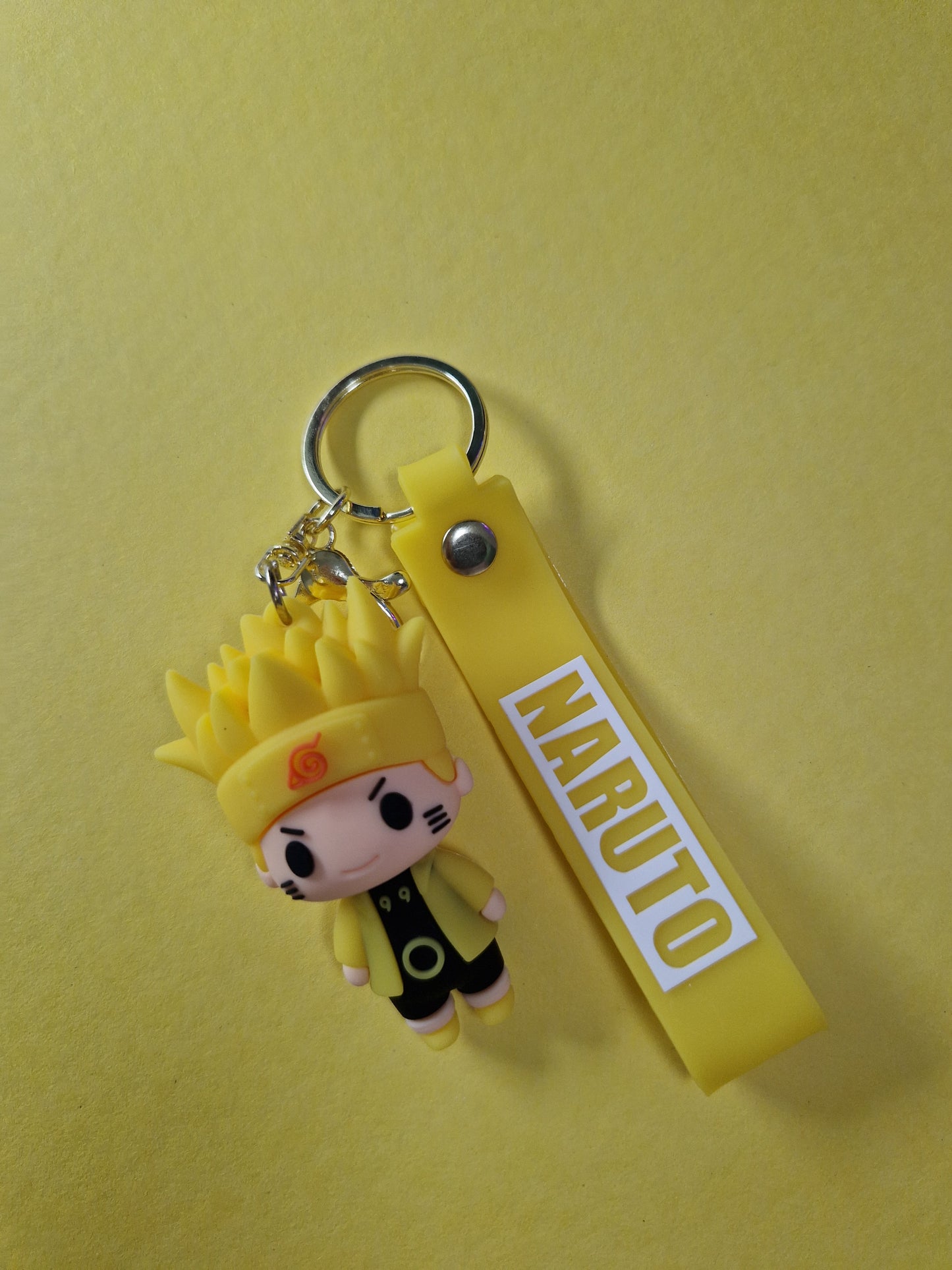 Breloc cu Naruto Uzumaki in varianta galbena pe fundal galben