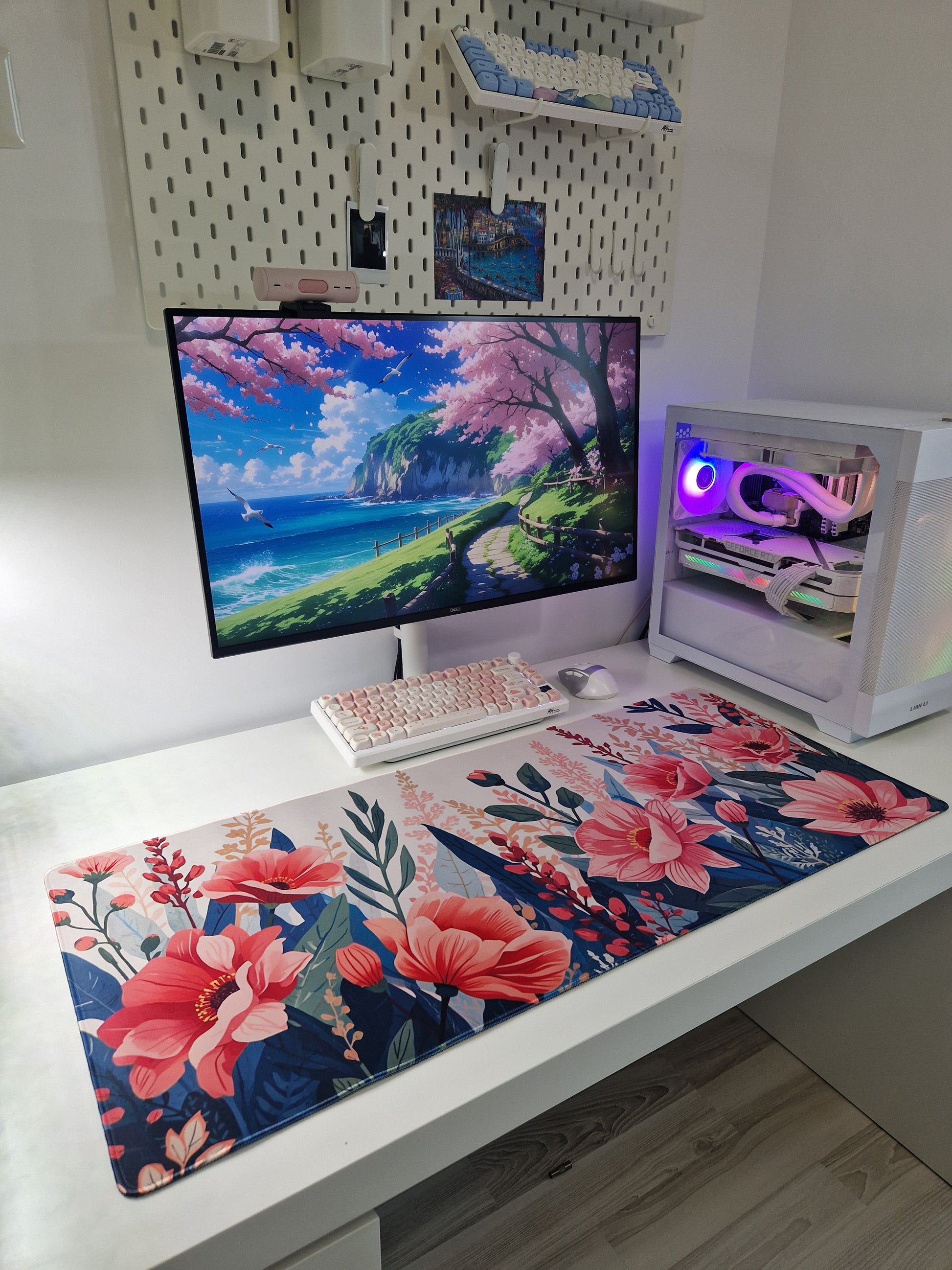 Mousepad floral de mari dimensiuni pe birou alb, cu tastatură și mouse plasate deasupra, într-un setup de gaming.
